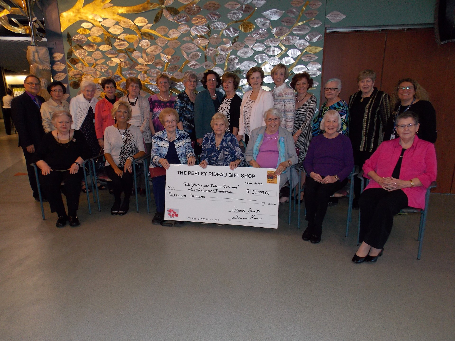 boutique giant cheque donation, group photo