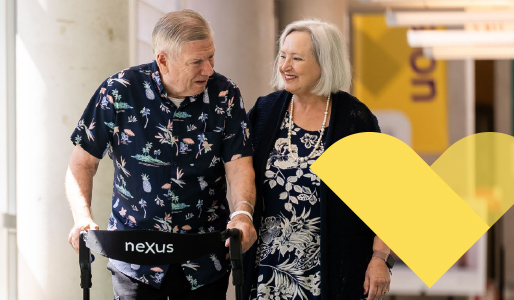 older adult male and female walking down a hallway
